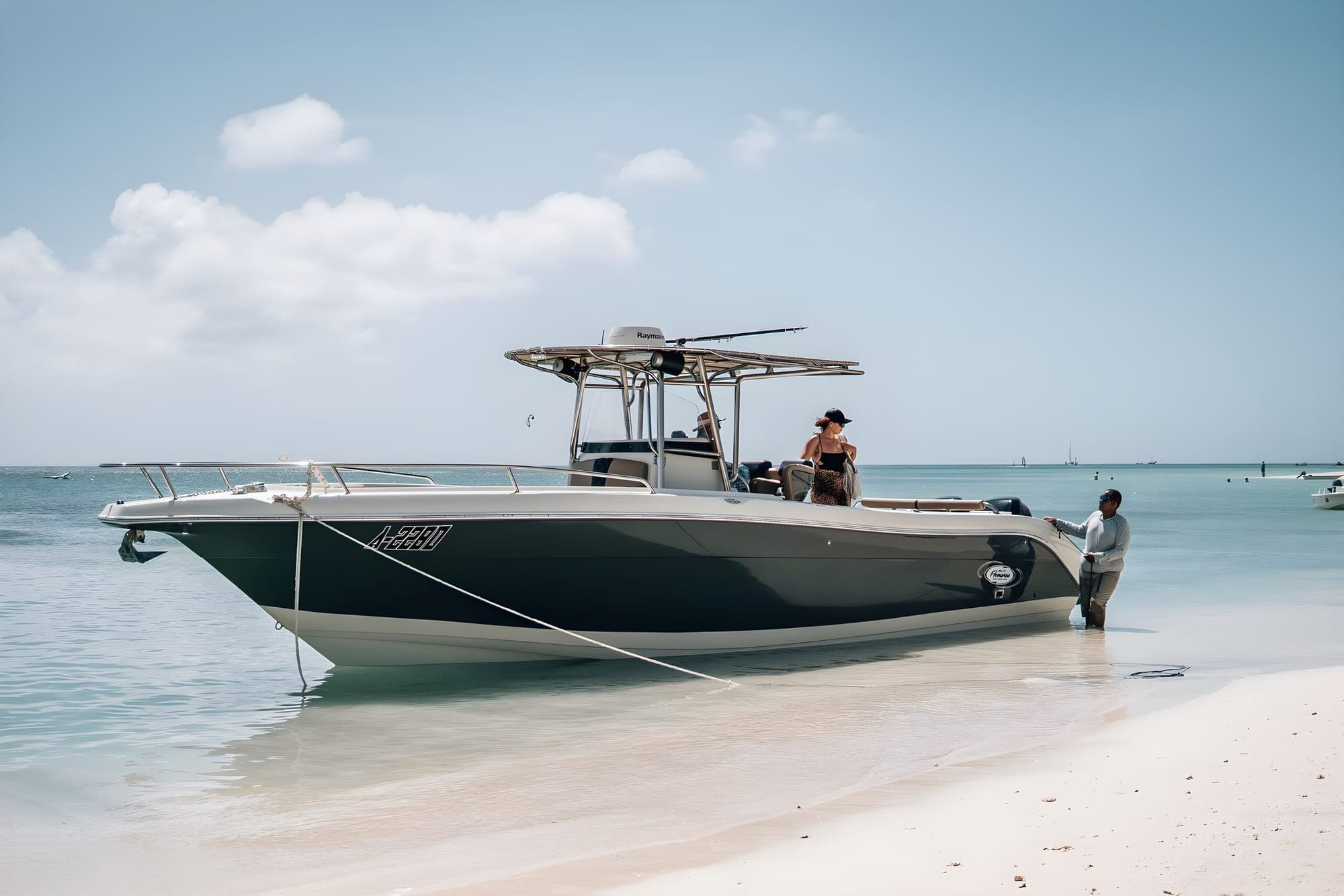 The crew’s dark-hulled center-console charter boat moored beside the beach in Aruba